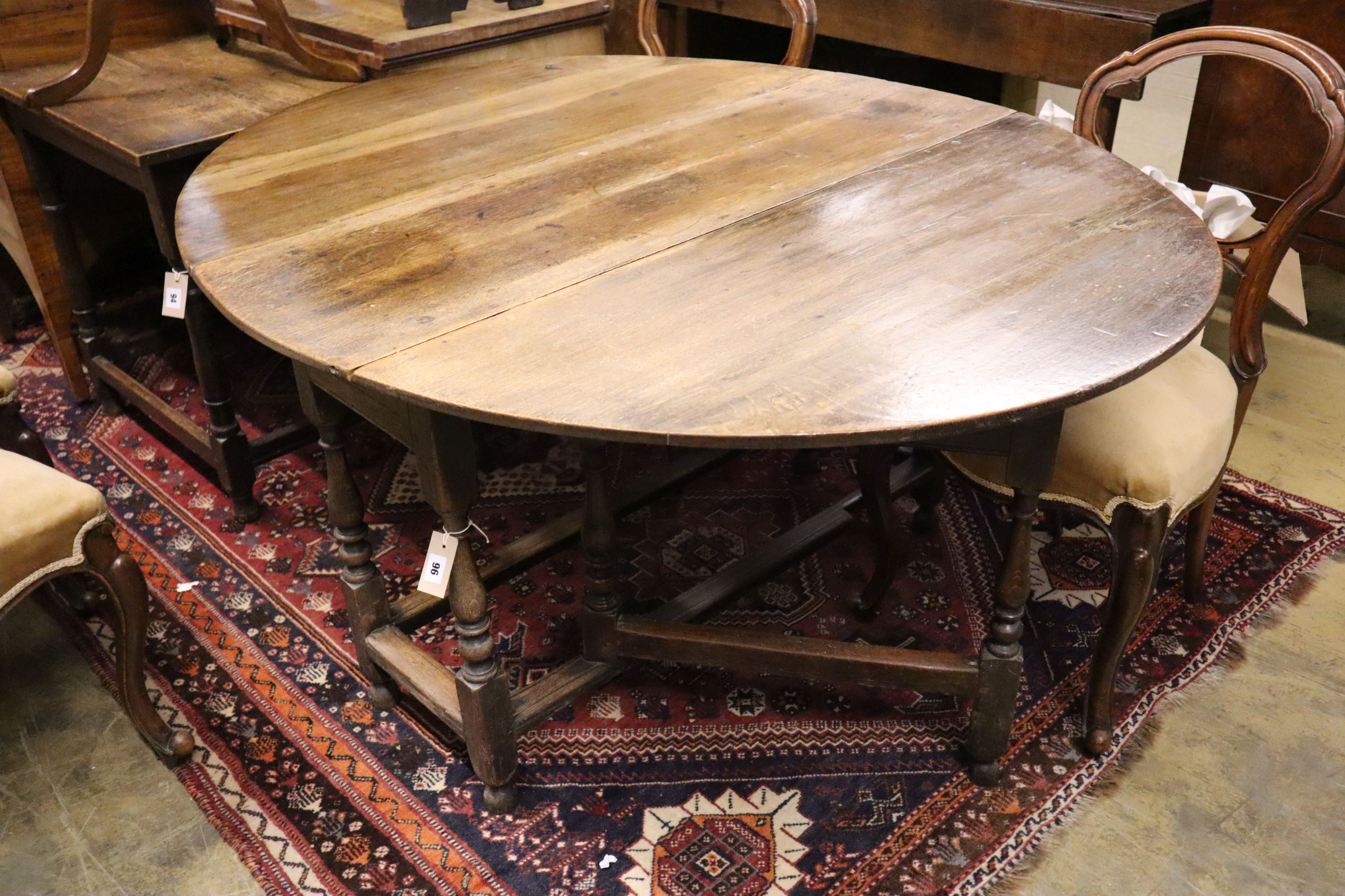 An early 18th century oak gateleg dining table, width 144cm extended, height 70cm